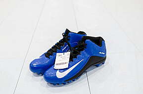A Pair of blue Nike cleats with white logo